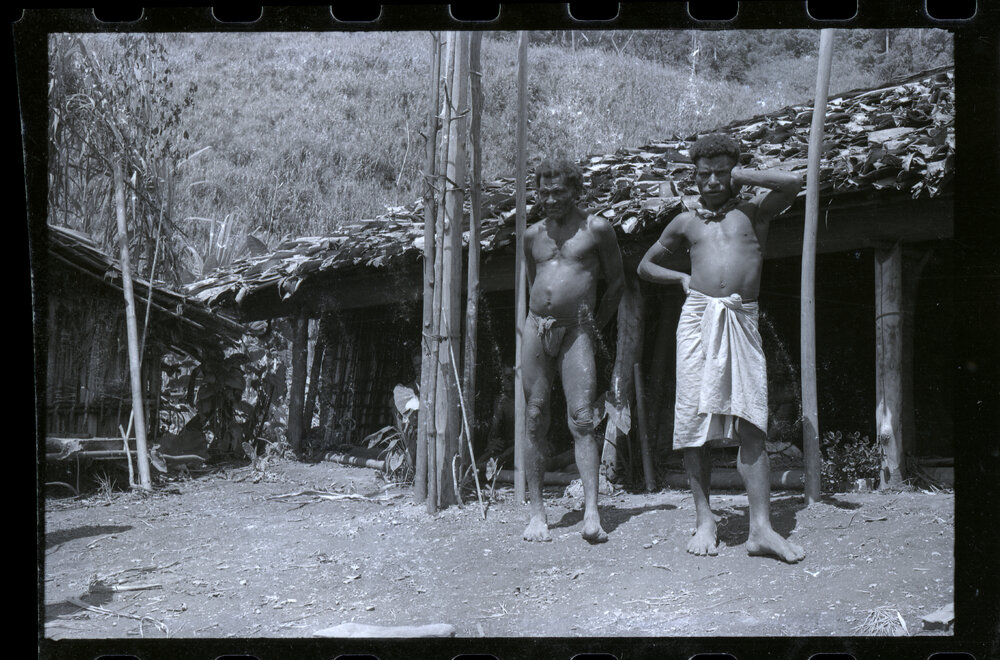 Two Men Standing Outside a Building
