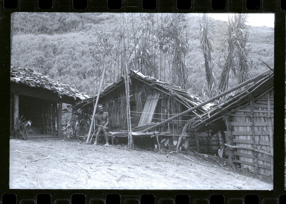 Man Sitting Outside a Building
