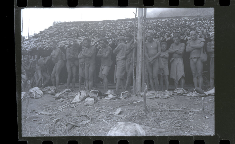 Line of Men and Children Standing Outside a Building