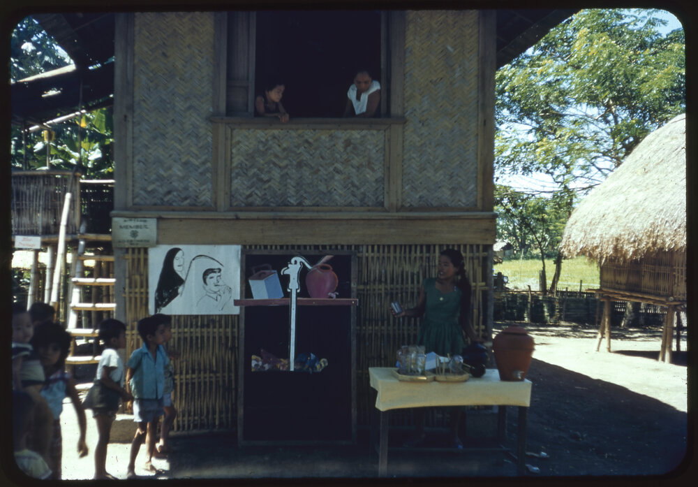 Women and Children Outside a Building