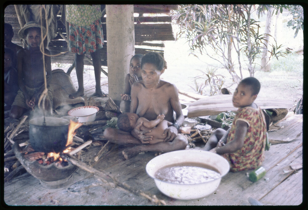 Women and Children Around Cooking Fire