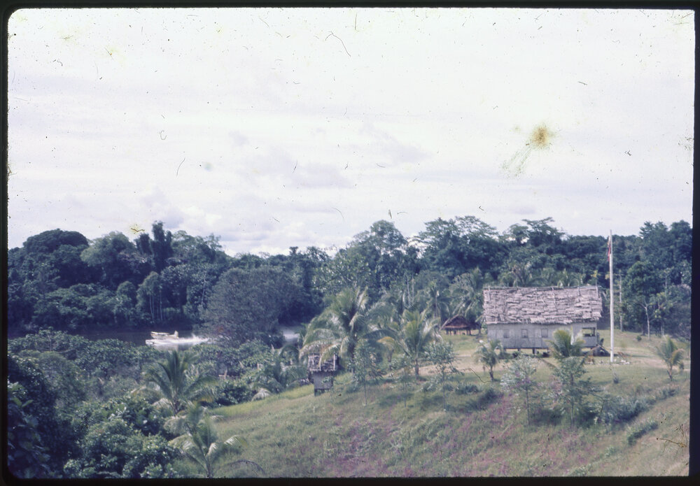 Buildings on Riverbank, with Seaplane in Background