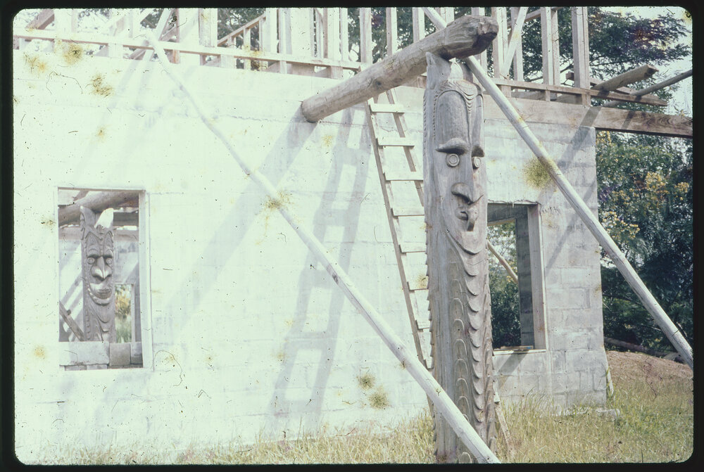 Carved Wooden Posts Attached to Building