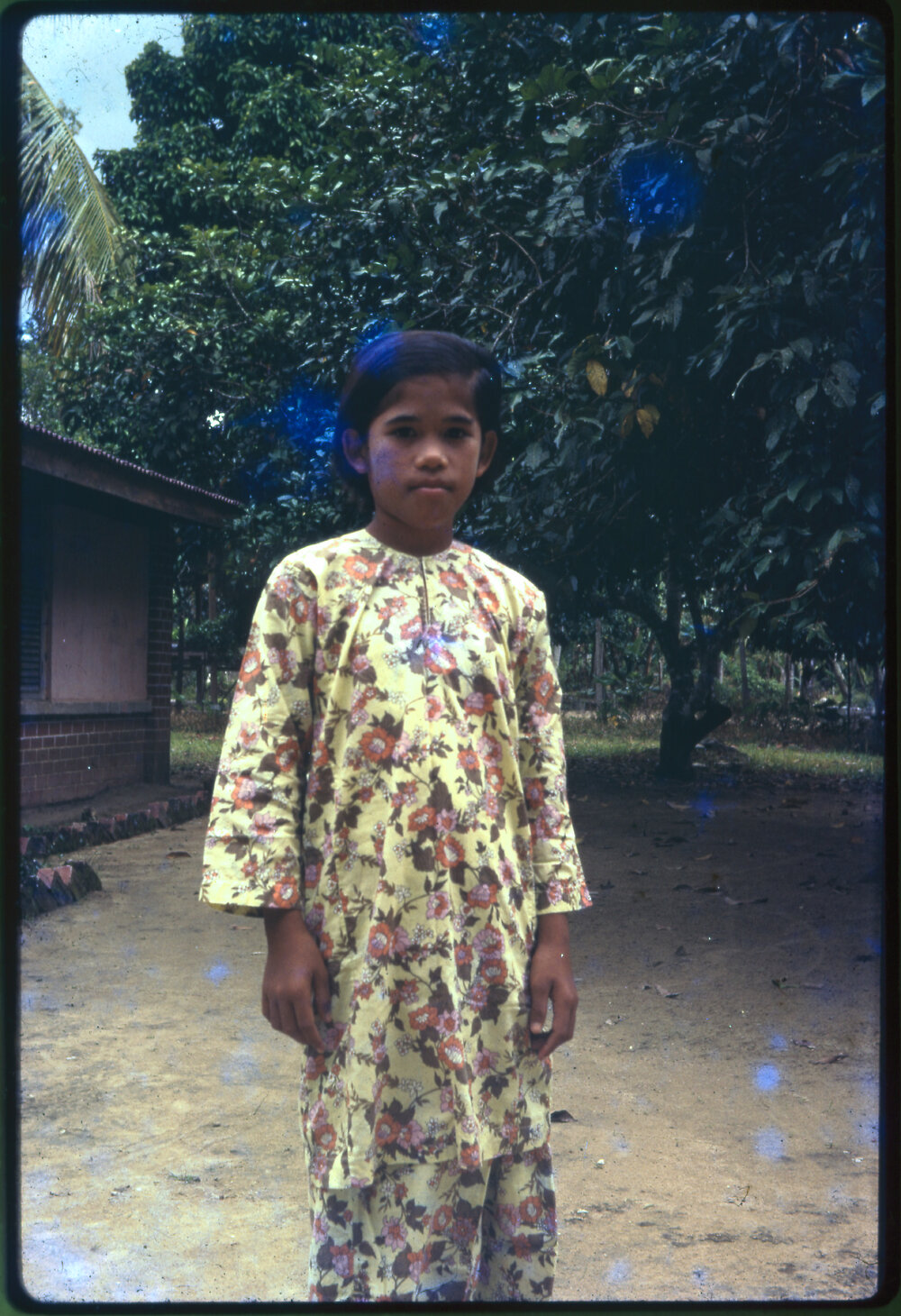 Girl Standing in Garden