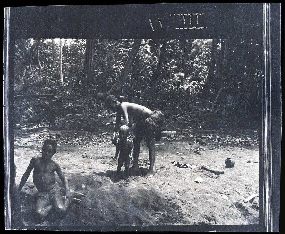 [Manum Island, New Guinea] A Mother Washing her Baby at the Water-hole