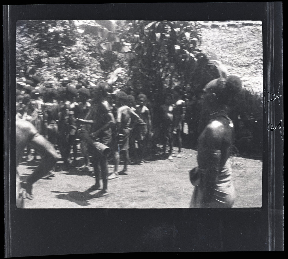[Manum Island, New Guinea] The Men of Waia Watching the Men of Dugulaba Take Away the Food