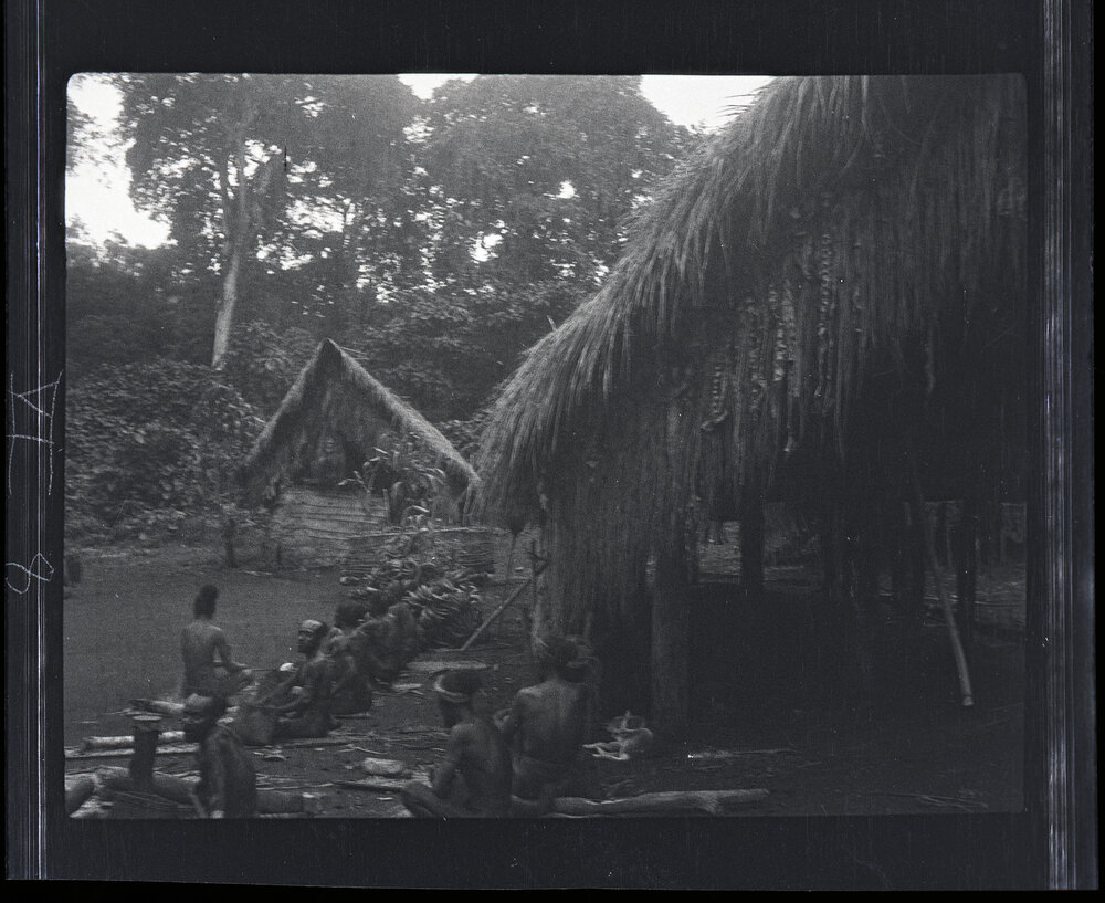 [Manum Island, New Guinea] Men of Waia Sitting Outside Arorŋabia&rsquo;s New House