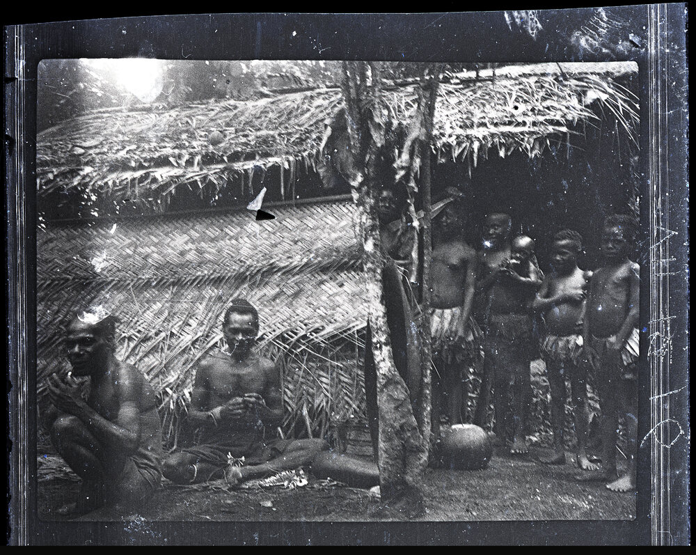 [Manum Island, New Guinea] A Group of Men in a Homestead