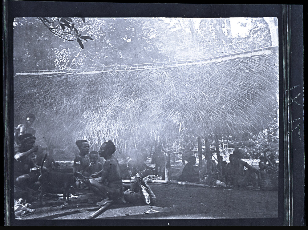 [Manum Island, New Guinea] Men Sitting, Waiting, Talking and Chewing