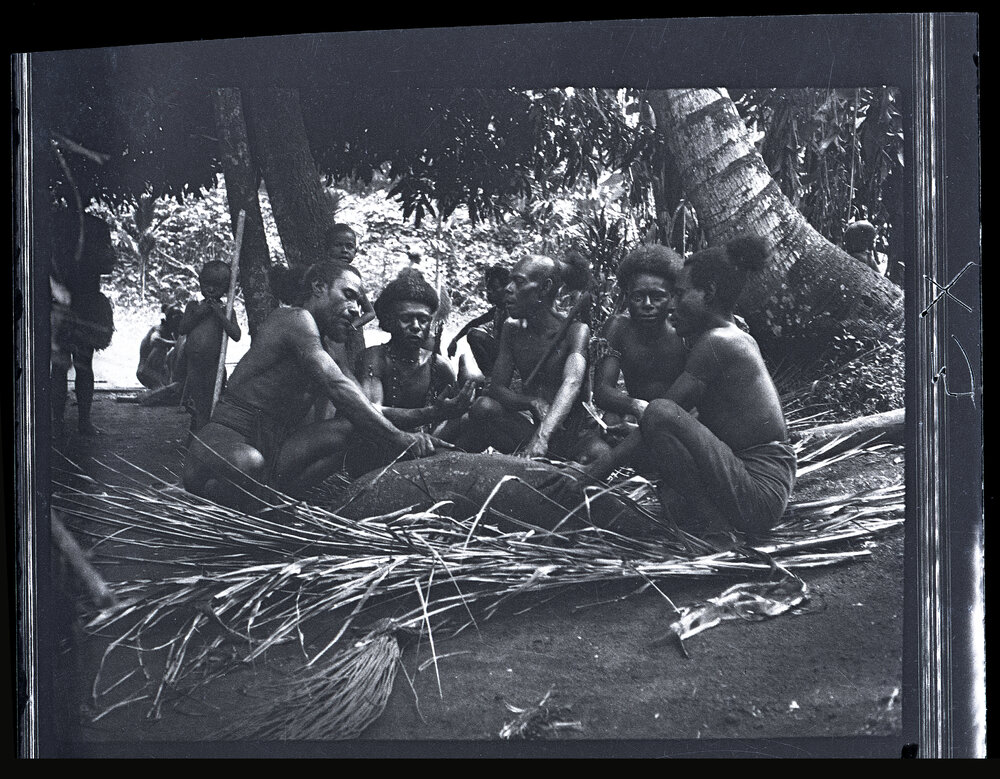 [Manum Island, New Guinea] Tiboiŋ and Others Cutting up Bazaba&rsquo;s Pig
