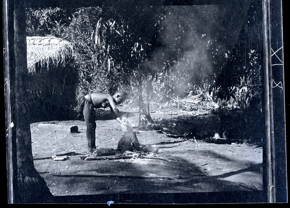 [Manum Island, New Guinea] Tou Stuffing a Large Hank of A&rsquo;u Fibre into a Pot Containing Dye