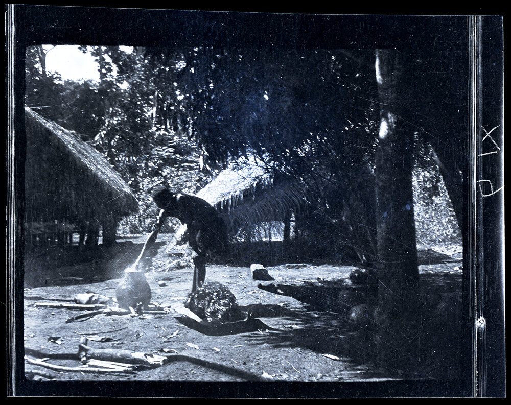[Manum Island, New Guinea] Tou Stuffing a Large Hank of A&rsquo;u Fibre into a Pot Containing Dye
