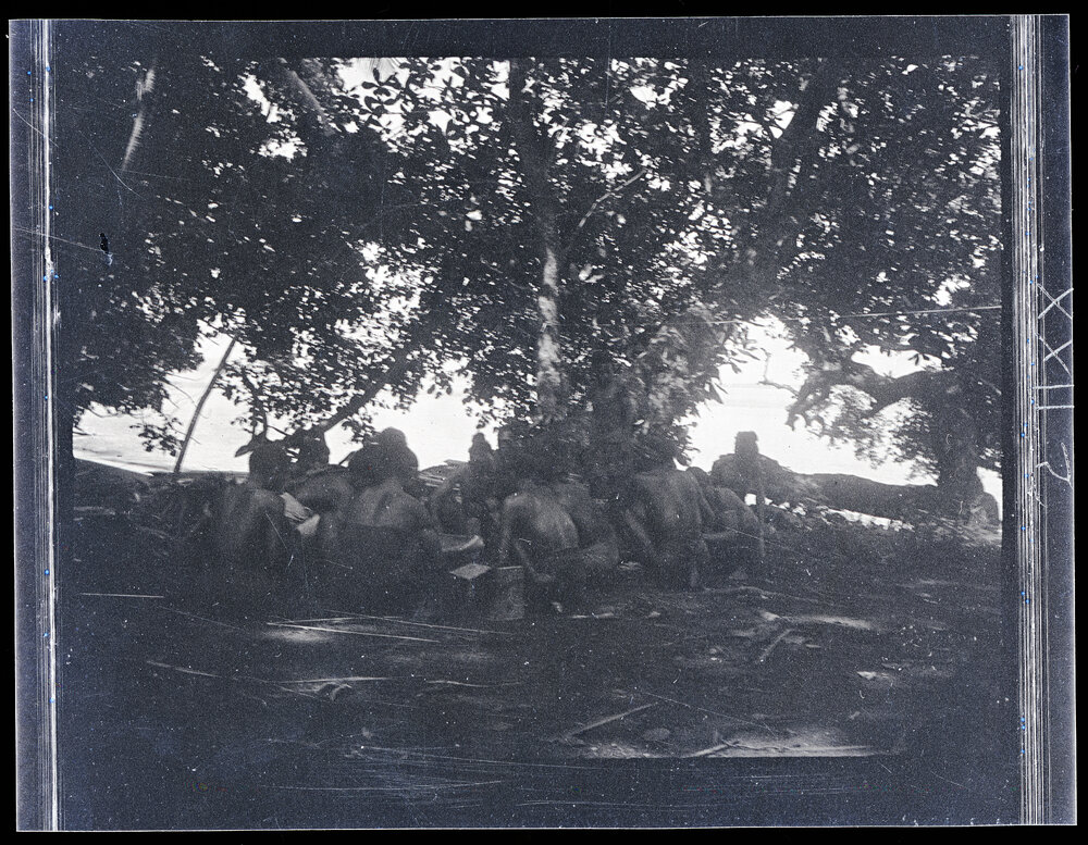 [Manum Island, New Guinea] Men Outside my [Wedgwood] House Cracking Galip Nuts