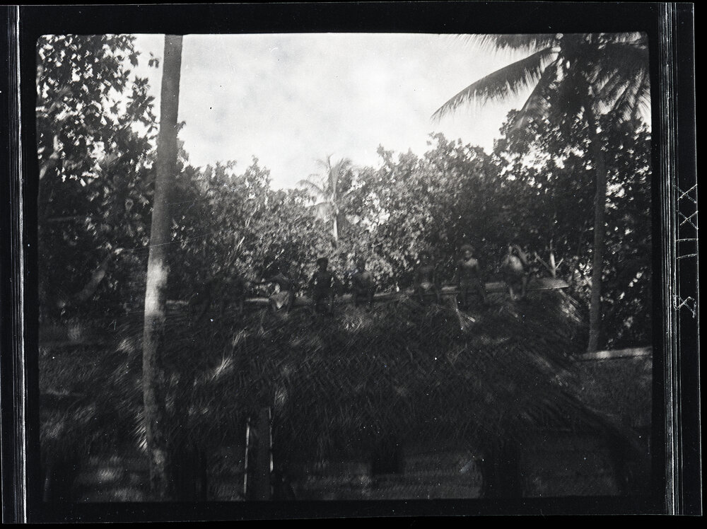 [Manum Island, New Guinea] Men on Top of the Roof Resting After Thatching