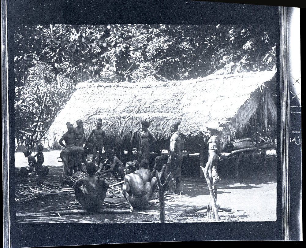 [Manum Island, New Guinea] The Men Cutting up the Pig