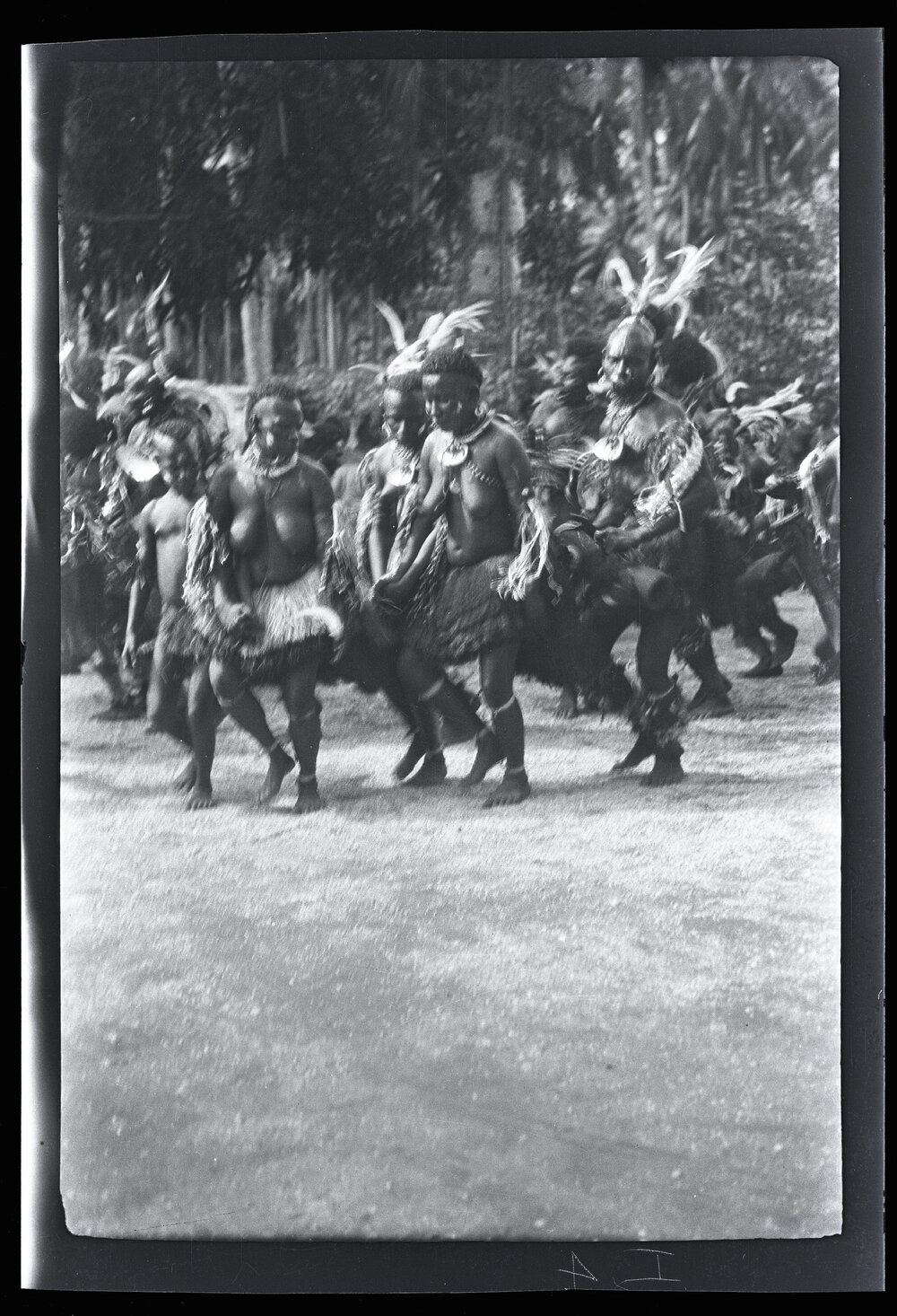 [Manum Island, New Guinea] The Men and Women of Kayan Dance in a Ring