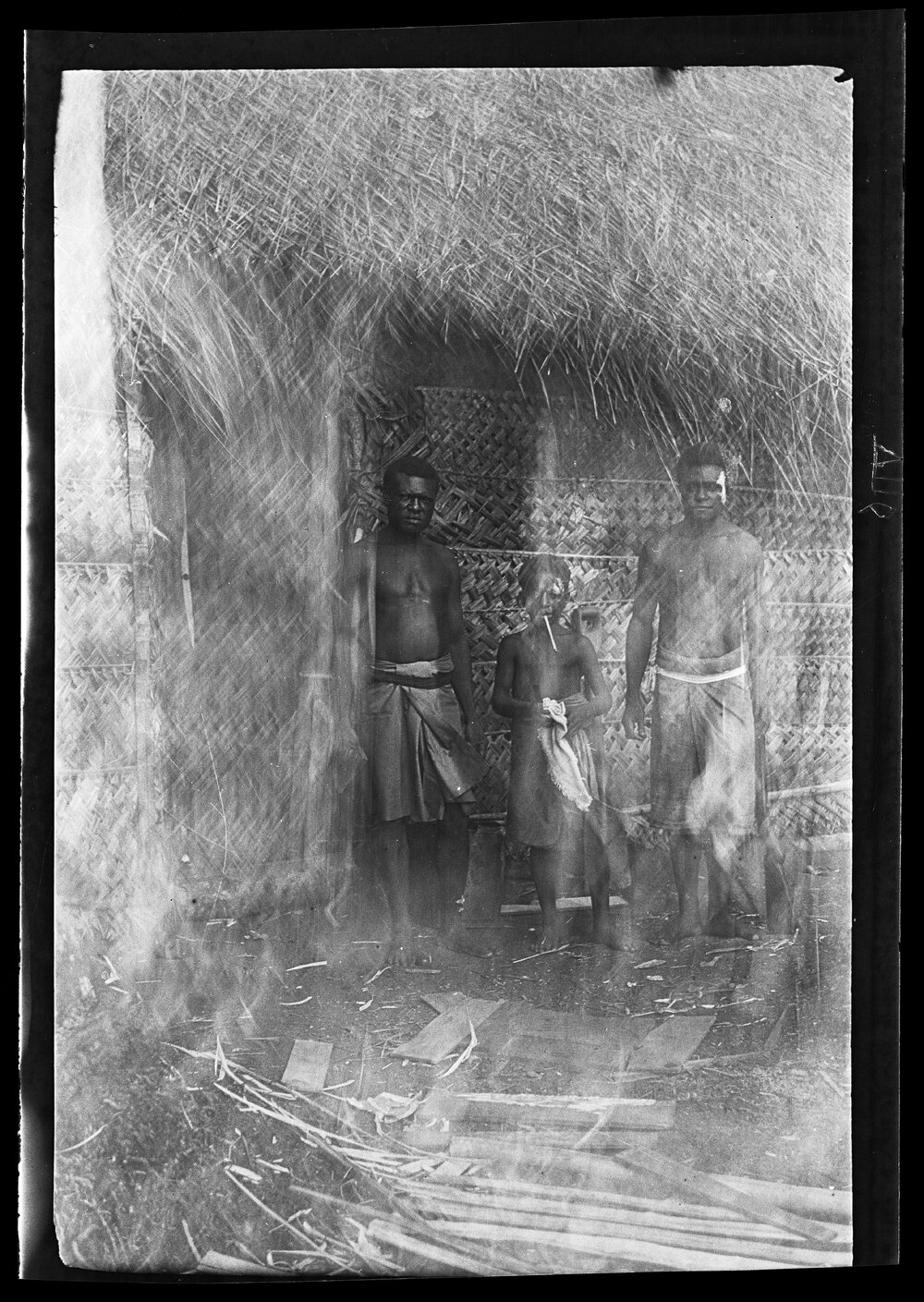 [Manum Island, New Guinea] Joseph, Maswash and Mewo at the Door of CHW&rsquo;s [Camilla H Wedgwood] House