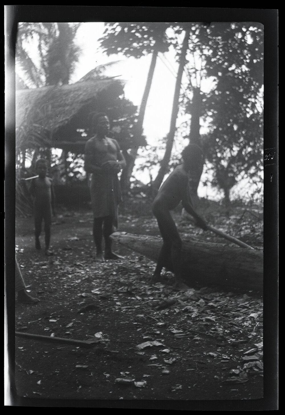 [Manum Island, New Guinea] A Lad Making a Canoe for Himself