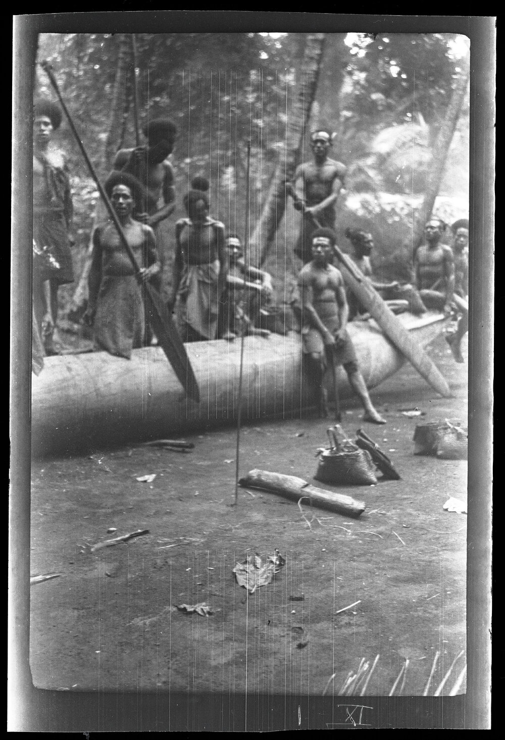 [Manum Island, New Guinea] Some Men of Yassa Visiting in Mamboti&rsquo;s Homestead Display a Big Steering Paddle which they have Brought