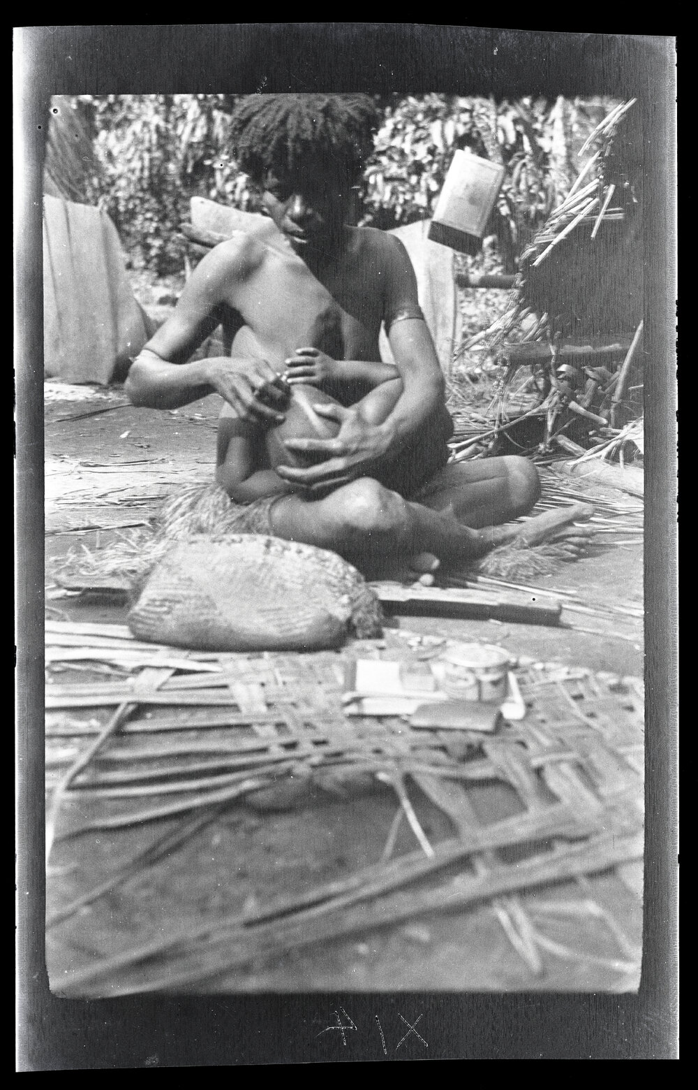 [Manum Island, New Guinea] Buburŋ Shaves the Head of her Son Abenaŋ, while he Sucks at her Breasts