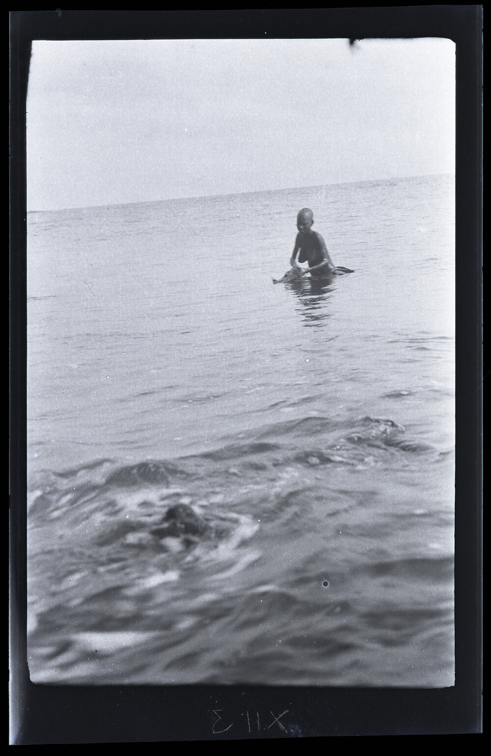 [Manum Island, New Guinea] Tsomoraua Washing Herself in the Sea with Leaves