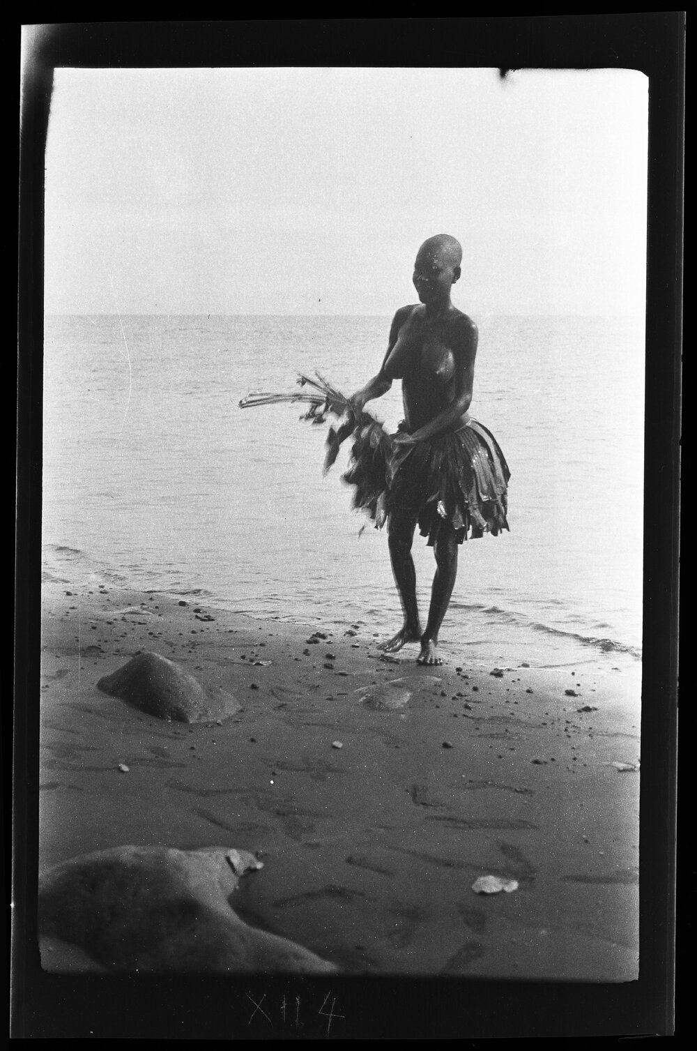 [Manum Island, New Guinea] Tsomoraua Coming out of the Sea with a Used Bunch of Leaves which she will Throw Away and get Some More