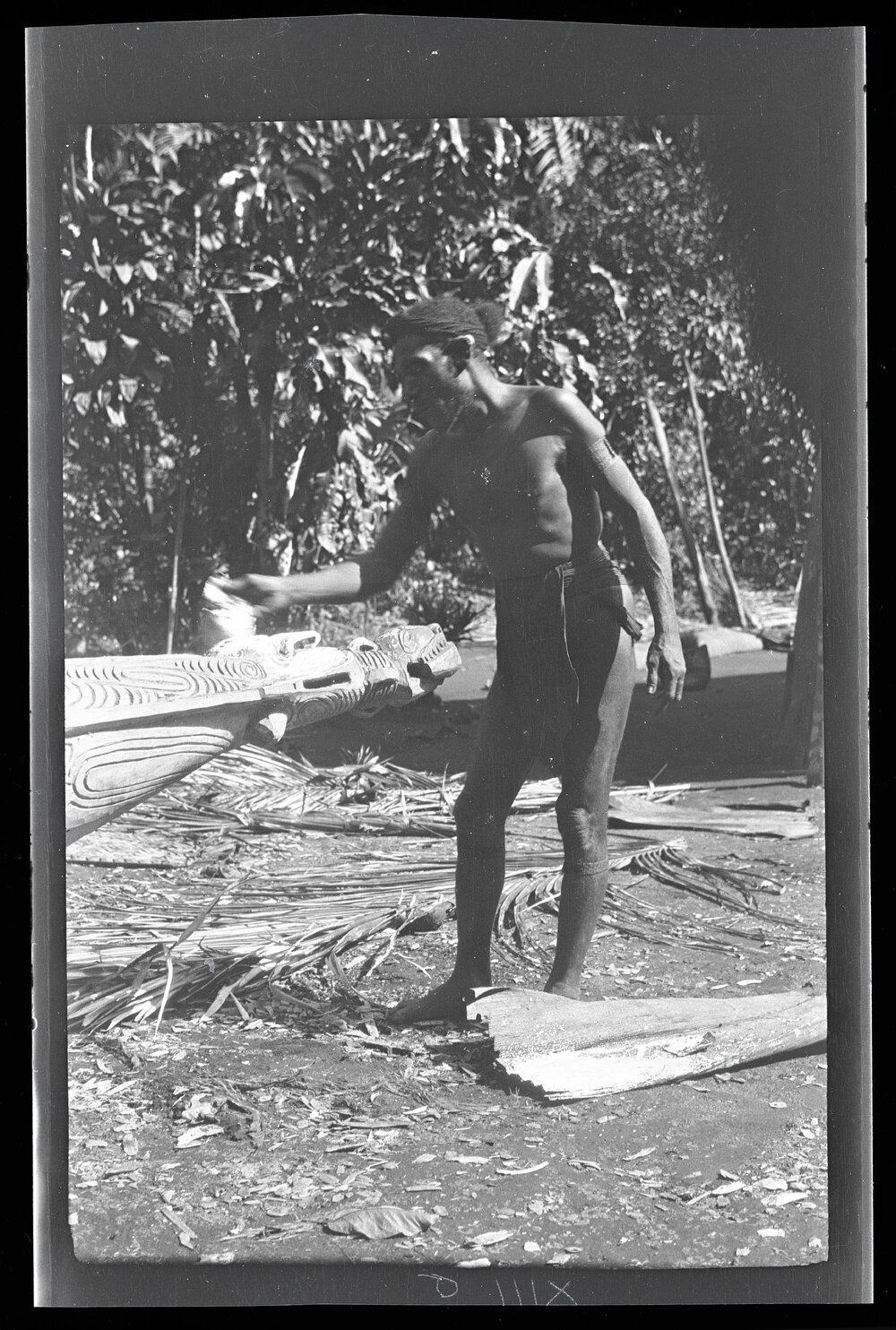 [Manum Island, New Guinea] Ruaŋatago Treating the Carved "Prow" at the Other End in the Same Way