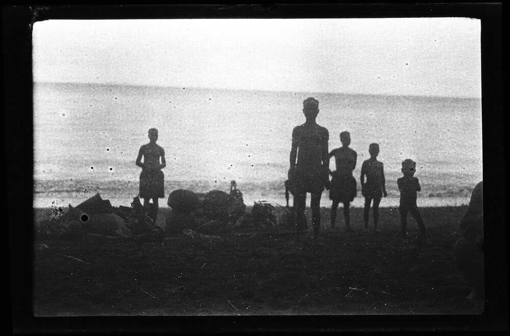 [Manum Island, New Guinea] Galip Nuts and Trays of Food in Leaf Bundles Waiting on the Beach to be Loaded onto the Canoes
