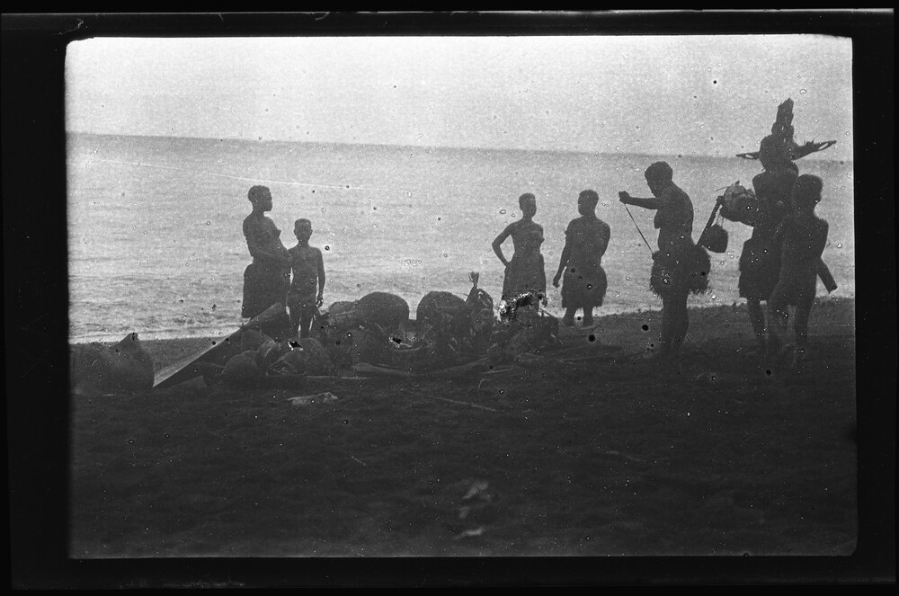 [Manum Island, New Guinea] Galip Nuts and Trays of Food in Leaf Bundles Waiting on the Beach to be Loaded onto the Canoes
