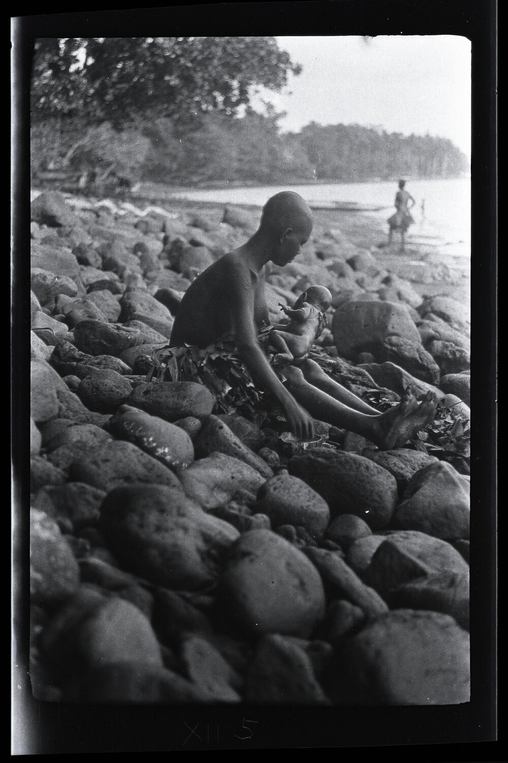 [Manum Island, New Guinea] Tsomoraua Having Finished her own Bath, Proceeds to Wash the Baby in Fresh Water Contained in a Coconut Shell