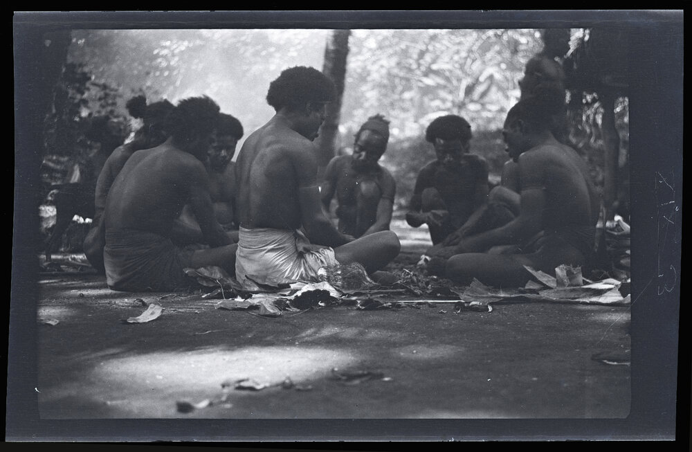 [Manum Island, New Guinea] Work Over. Some of the Tsokali Men Gather Round to Crack Galip Nuts Supplied by Mamboti
