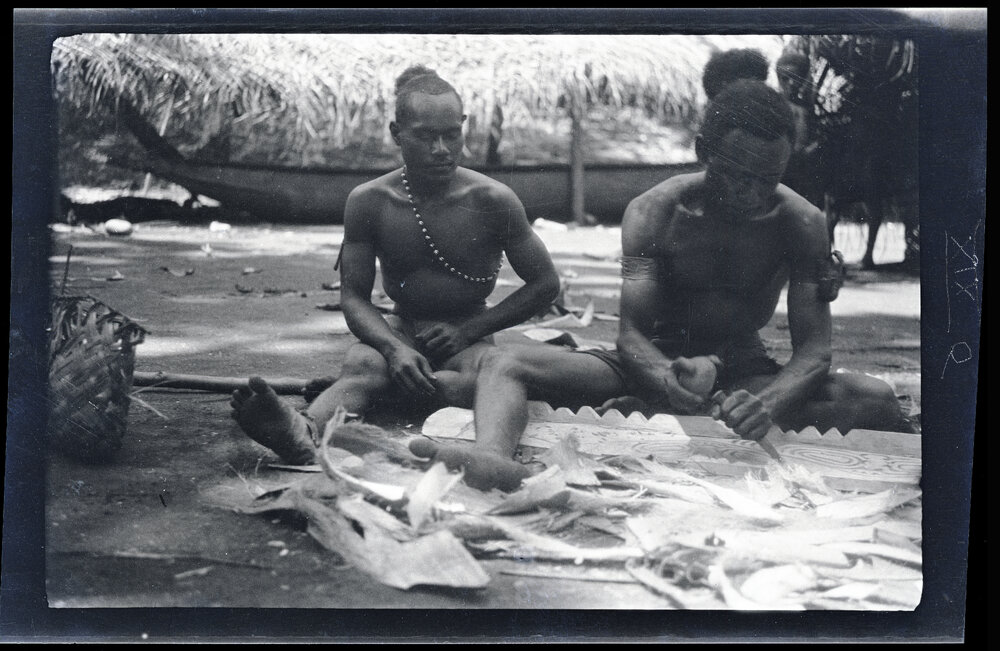 [Manum Island, New Guinea] Zabe Carving a Perapera Plank. &rsquo;Asu&rsquo;asu Watching