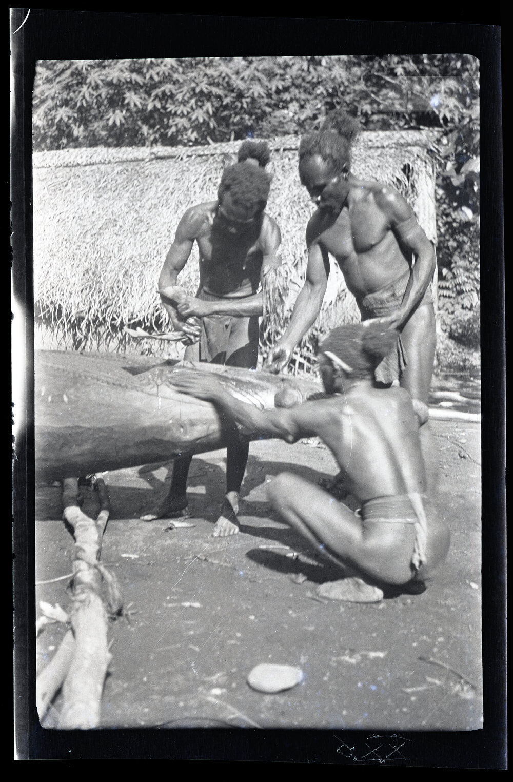[Manum Island, New Guinea] Canoe Painting at Yabururu's. Three Elderly Men Painting the Prow of the Canoe