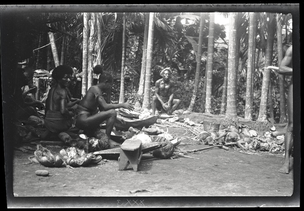 [Manum Island, New Guinea] Scraping Coconuts