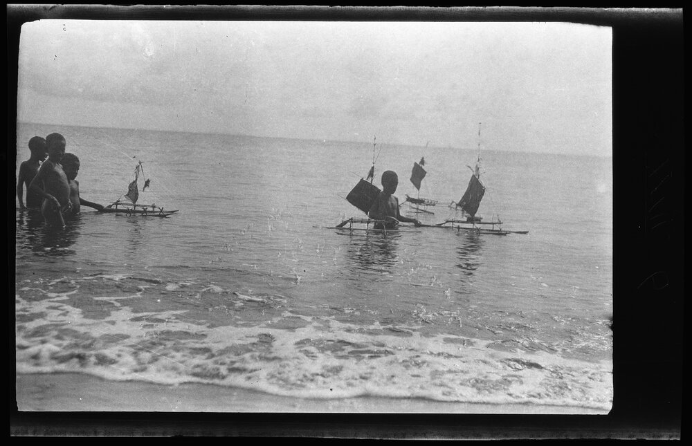 [Manum Island, New Guinea] Little Boys of Waia Playing in the Sea with Toy Canoes