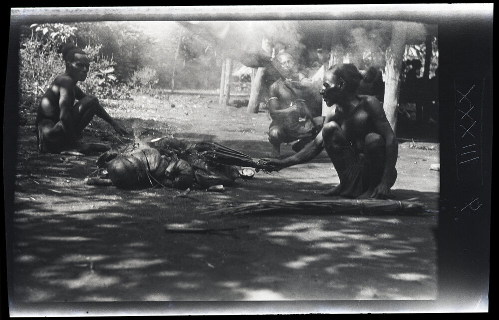 [Manum Island, New Guinea] Drying the Wild Banana Leaves over a Smokey Fire 