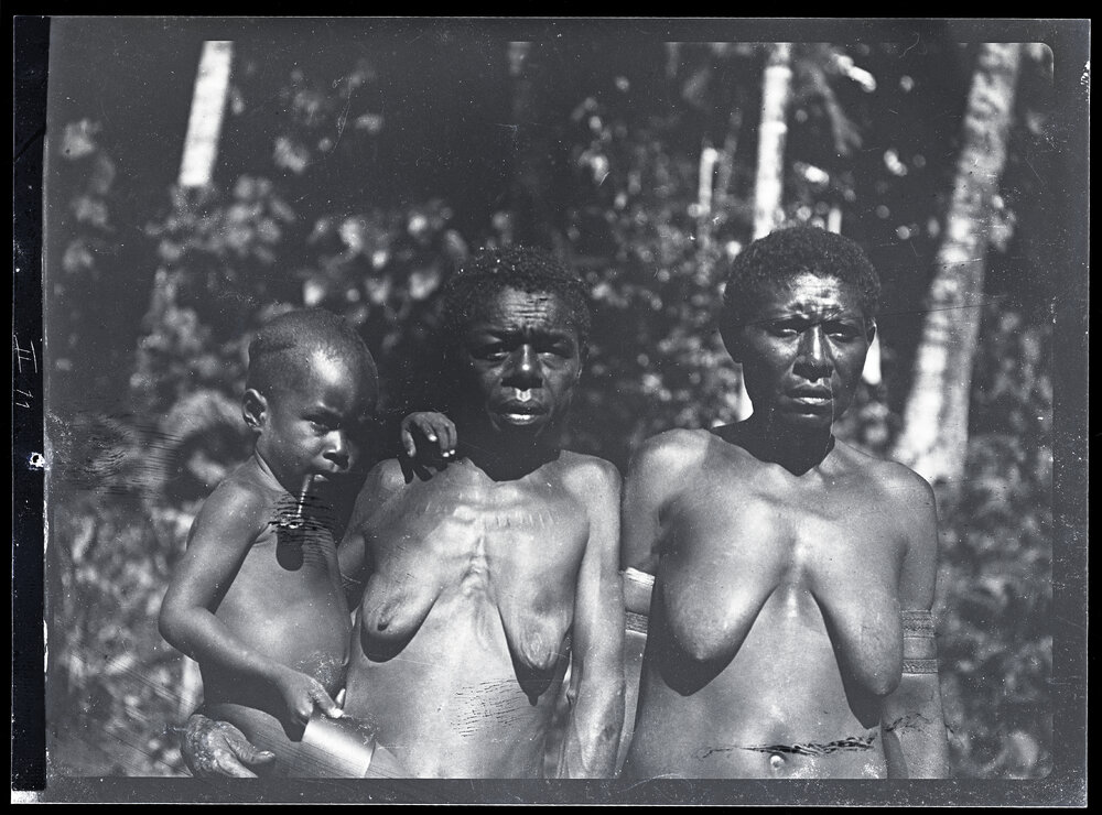 [Manum Island, New Guinea] Tsedam&rsquo;s Two Wives, Morua and Tu&rsquo;ura, with his Adopted Son Momai