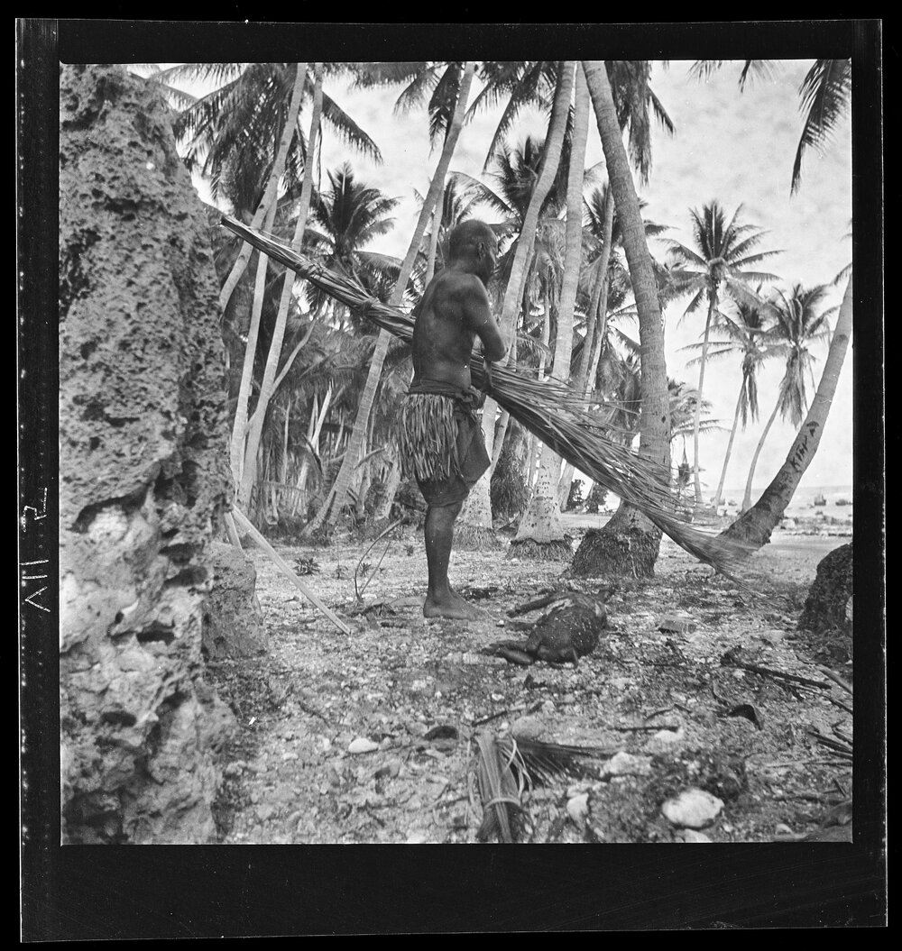 [Narau] Diaikwen of Meneŋ Making a Torch with which to Singe a Piglet he has Killed