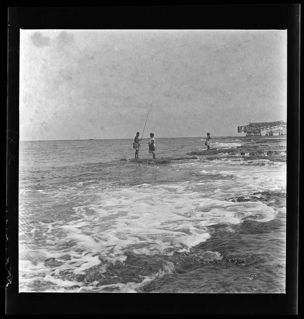 [Narau] A Man and Woman Fishing with Rod and Line at the very Edge of the Reef at Low Tide