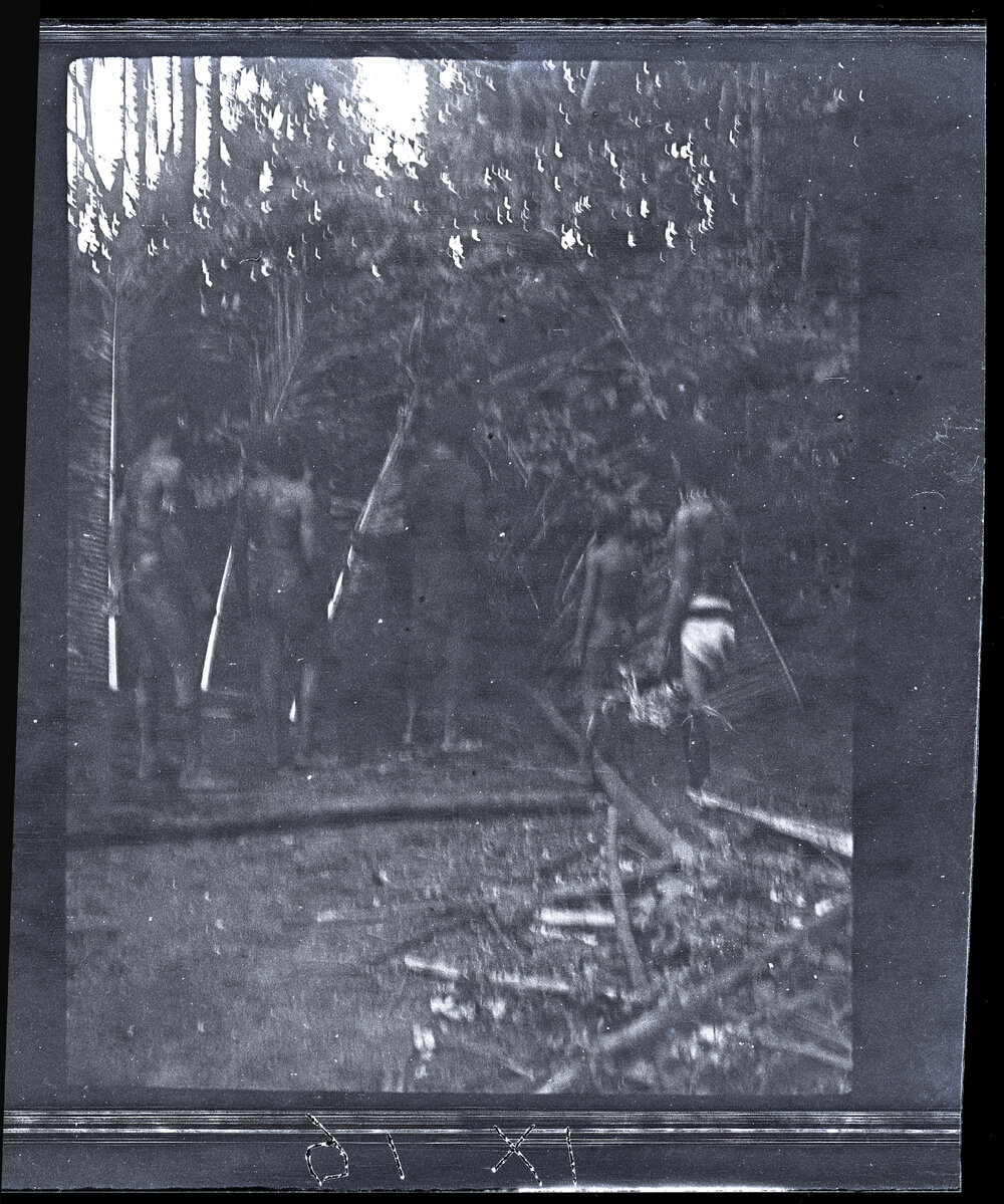 [Manum Island, New Guinea] ? Men and Child Inspecting where the Pig will be Prepared