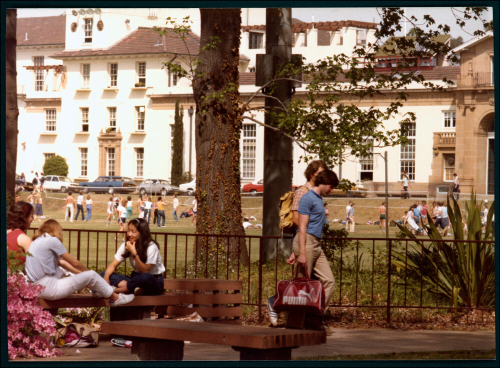Students with the Square and Physics Building Behind