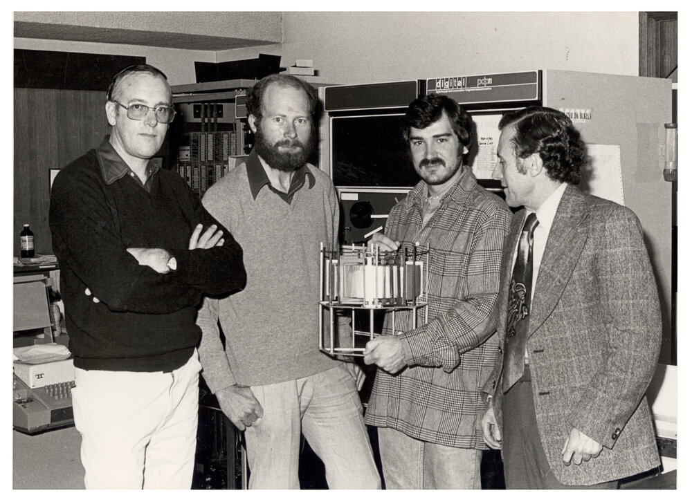 Physics Staff with Model of Proposed Tokamak