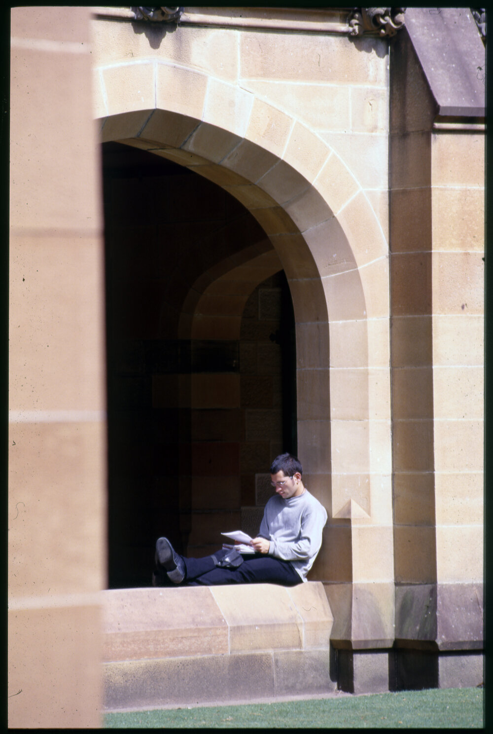 Student Sitting in Quadrangle Cloisters