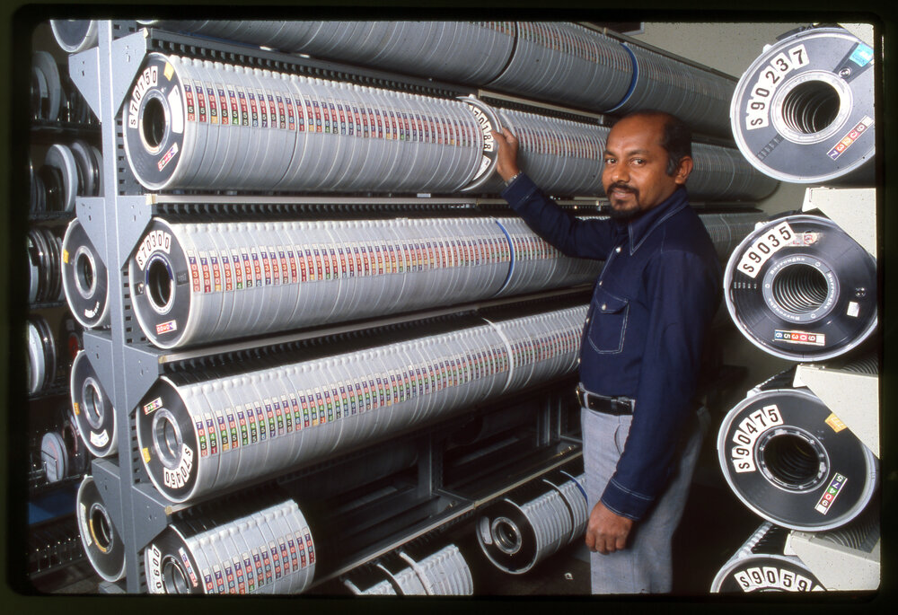 Staff Member with Rows of Audio-Visual Material