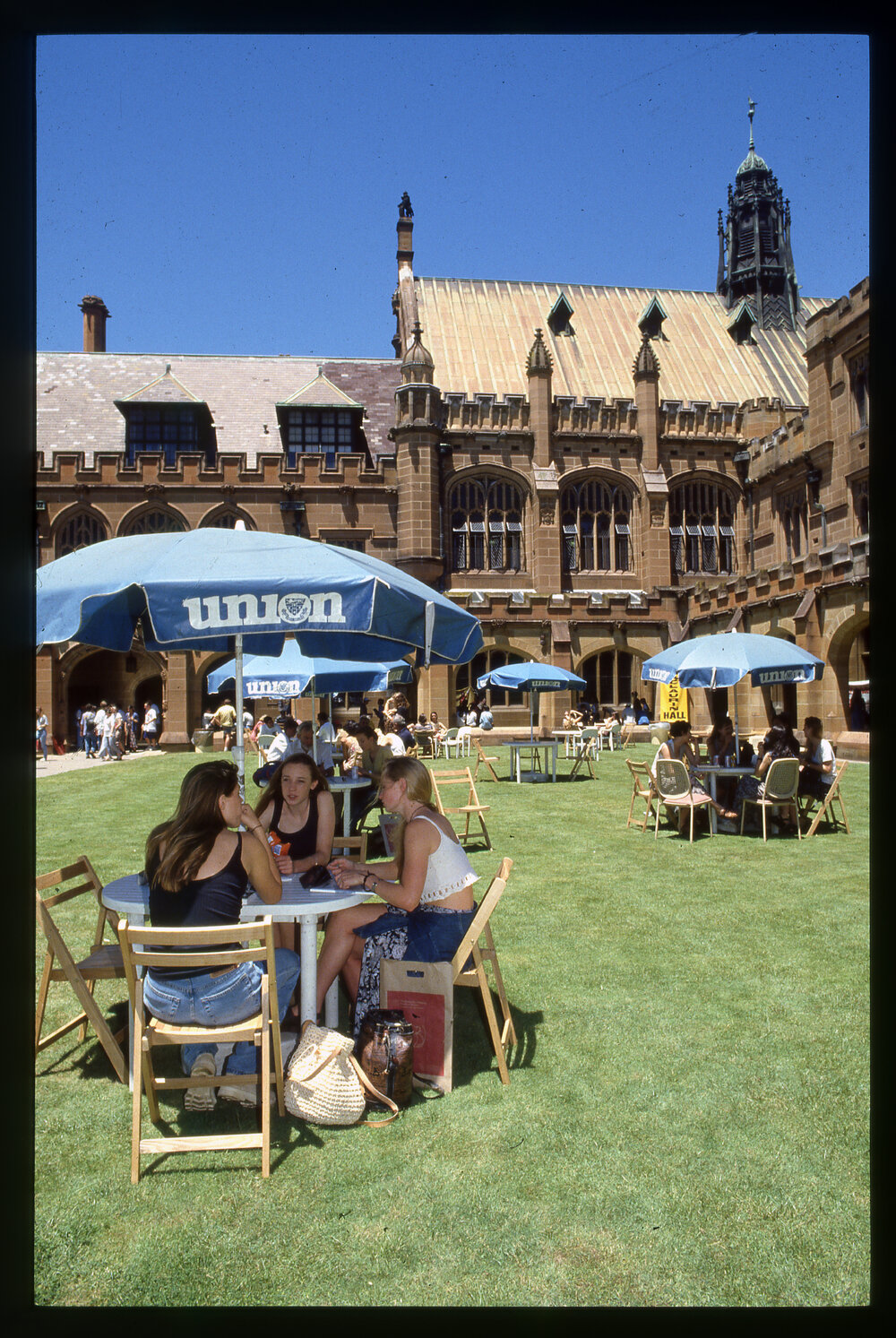 Students Sitting at Tables in the Quadrangle