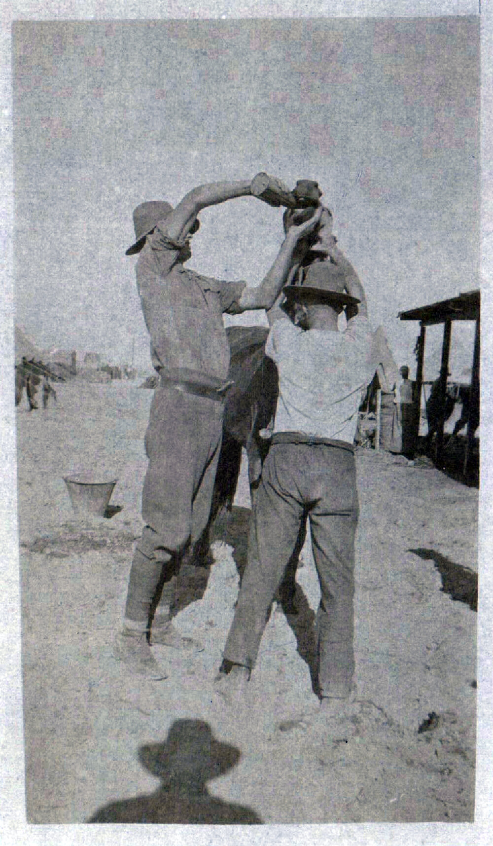 Men Tending to a Horse Near a Stable