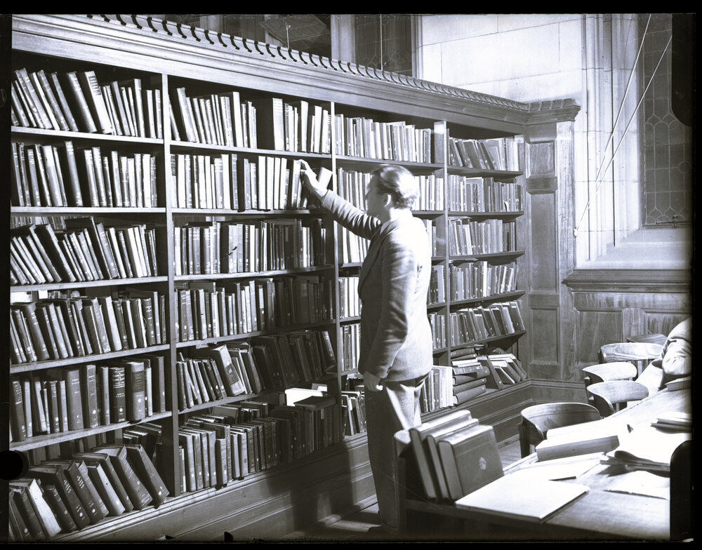 Selecting a Book in the Fisher Library, MacLaurin Hall
