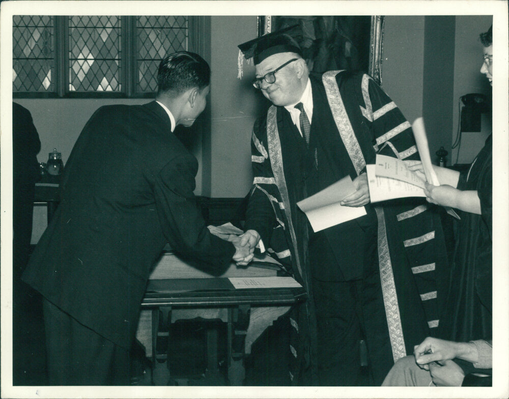 Vice-Chancellor Sir Stephen Roberts presenting student with a Social Work Diploma