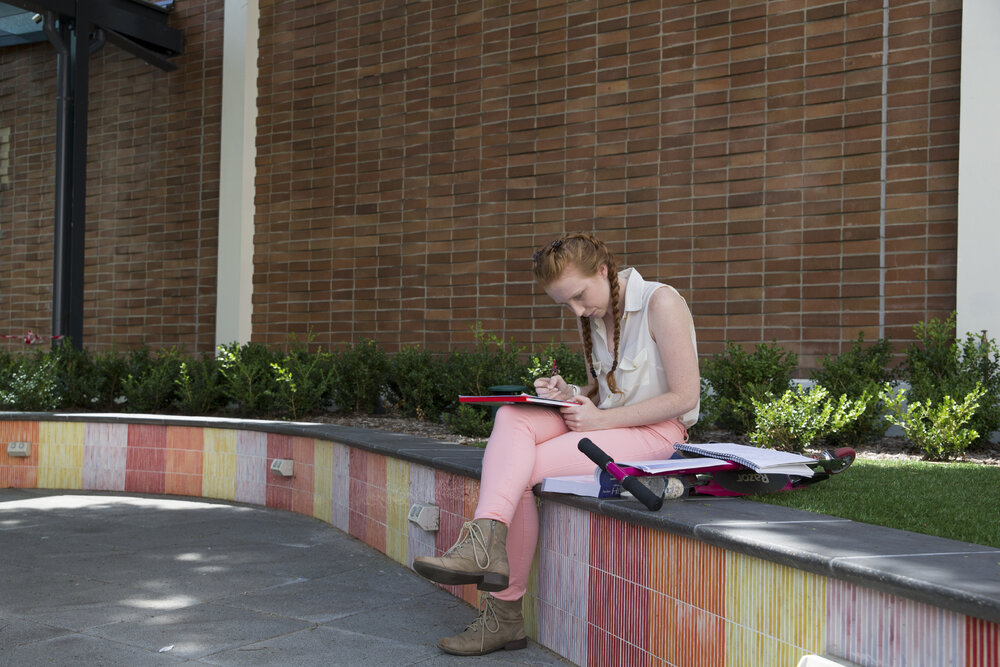 Student Studying in Holme Building Courtyard