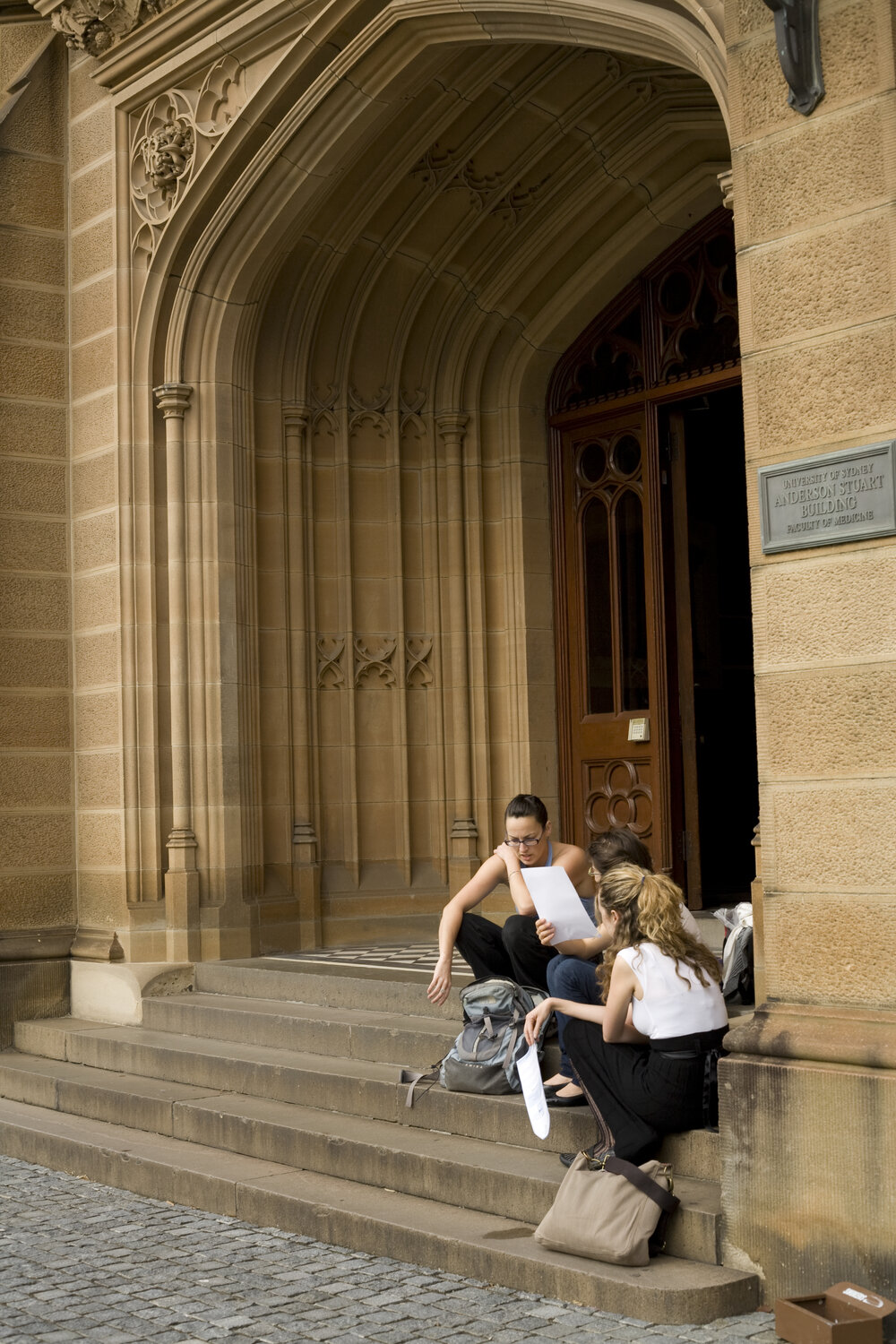 Students Sitting in the Entranceway to Anderson Stuart Building